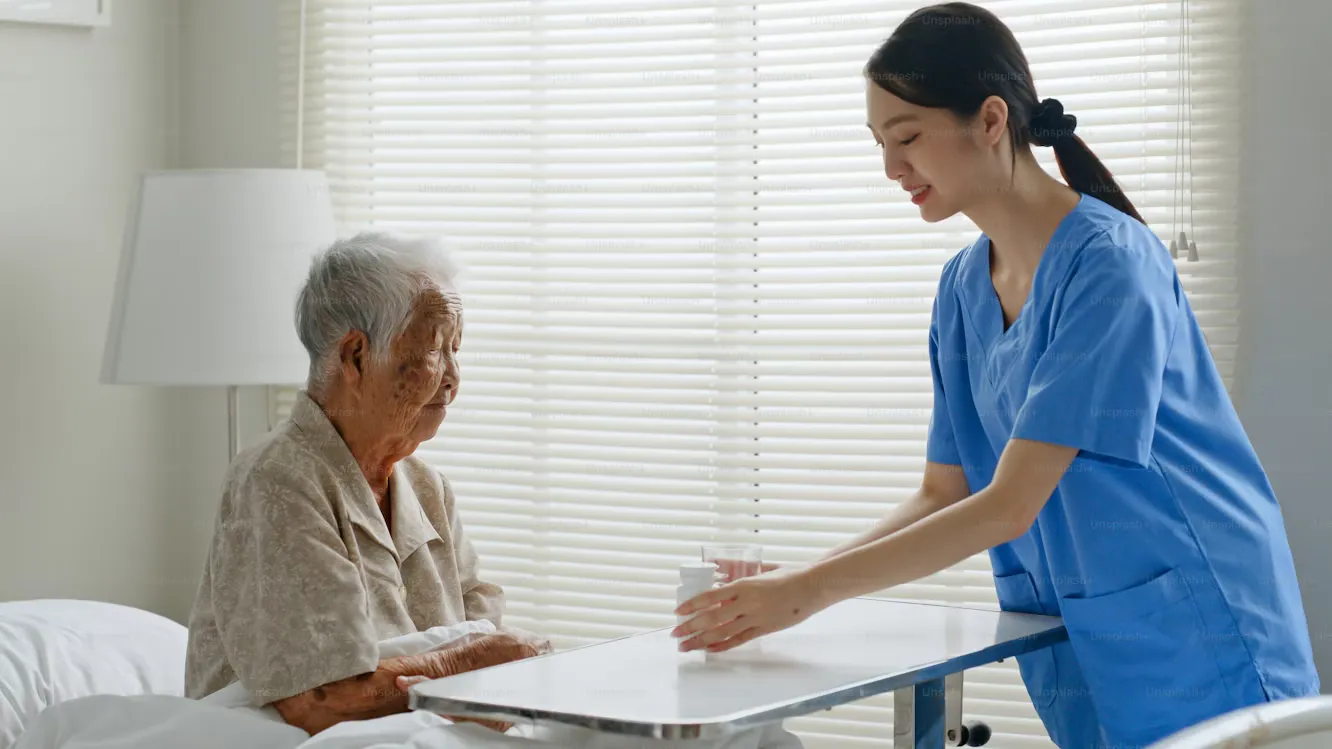 Caregiver supporting an elderly person at home